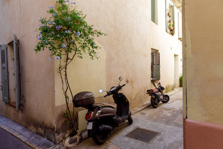 ANTIBES, FRANCE - 17 SEPTEMBER 2017: motorcycles parked on narrow street of old european town, Antibes, Franceのeditorial素材