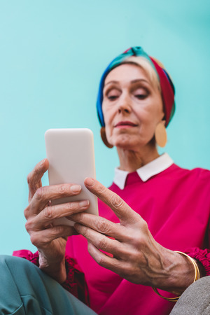 selective focus of senior woman using smartphoneの写真素材