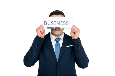middle aged businessman closing eyes with newspaper isolated on whiteの写真素材