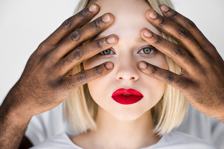 cropped image of african american boyfriend touching blonde girlfriend face isolated on white