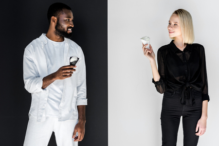 multicultural couple looking at each other with ice cream cones, yin yang conceptの写真素材
