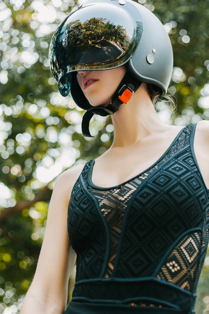 girl posing in black motorcycle helmetの写真素材
