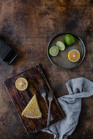 top view of piece of tasty lemon pie on cutting boardの写真素材