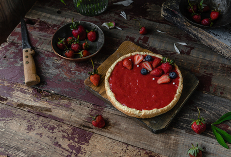 delicious cooked strawberry pie on wooden tableの写真素材