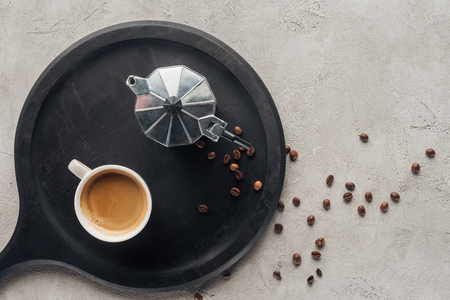 top view of cup of coffee and moka pot on concrete surfaceの写真素材