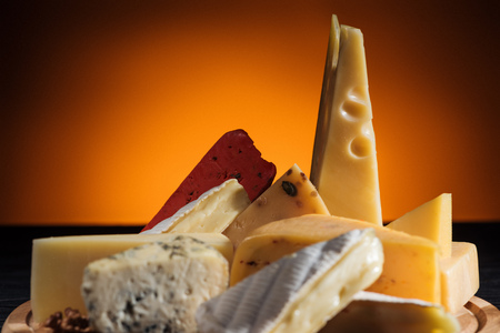 different types of tasty cheeses on orangeの写真素材