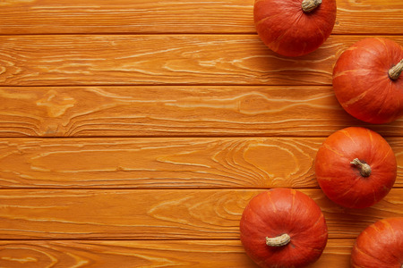 top view of whole ripe pumpkins on wooden backgroundの写真素材