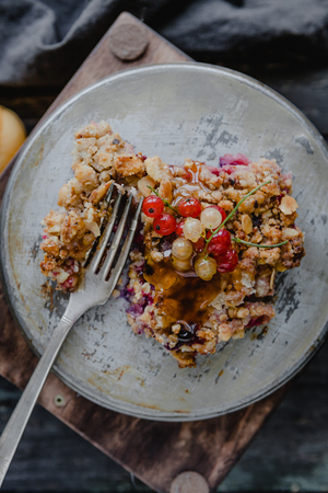 top view of piece of tasty pie with currants on plate