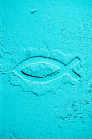 top view of fish symbol in blue flour textureの写真素材