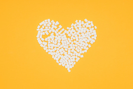 top view of heart of marshmallows isolated on orangeの写真素材