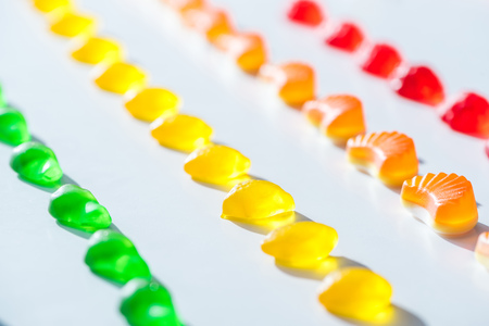 set of sweet green, yellow and red jelly candies on white