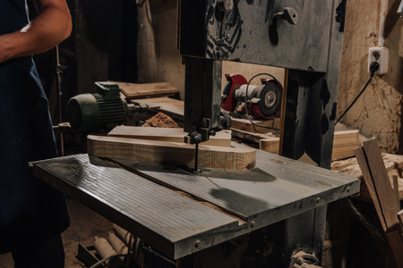 partial view of woodworker at wooden workshopの写真素材