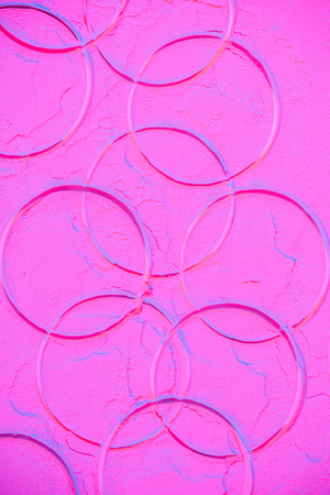pink neon flour texture with prints of circlesの写真素材