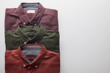 flat lay of three colored shirts isolated on whiteの写真素材
