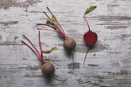 Small red beetroots on rustic wooden tableの写真素材