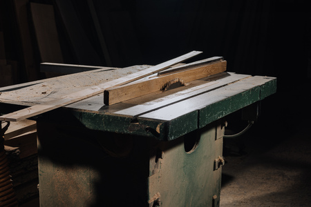 close up view of circular saw and materials at wooden workshopの写真素材