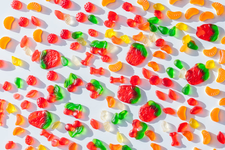 top view of tasty scattered jelly candies on whiteの写真素材