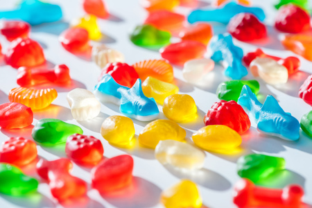 different colored jelly candies on white surfaceの写真素材