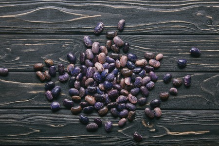 Dry large haricot beans on dark wooden tableの写真素材