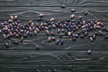 Purple haricot beans on dark wooden tableの写真素材