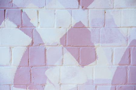 light brick wall with white and pink paint, abstract backgroundの写真素材