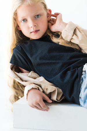 beautiful kid with long curly hair looking at camera isolated on whiteの写真素材