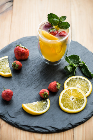 high angle view of fresh delicious summer drink with mint and fruits on slate boardの写真素材
