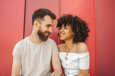 beautiful happy young stylish multiethnic couple smiling togetherの写真素材