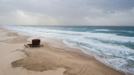 aerial view of bay watch house on empty sandy beach on cloudy day, Ashdod, Israelの写真素材