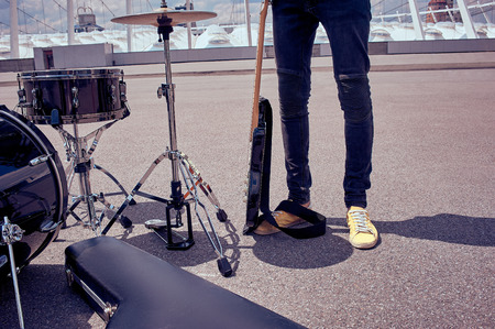 partial view of musician standing near musical instruments on streetの写真素材