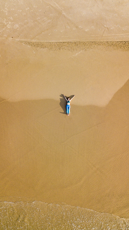 aerial view of woman relaxing on sandy beach, Ashdod, Israelの写真素材