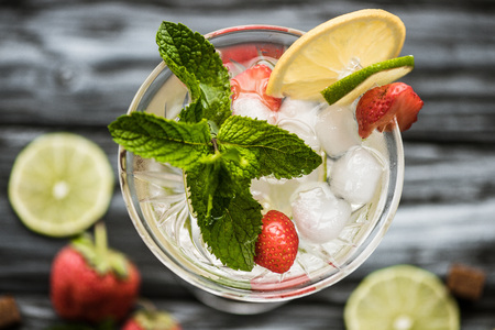 top view of cold strawberry mojito cocktail with mint and ice cubes in glassの写真素材