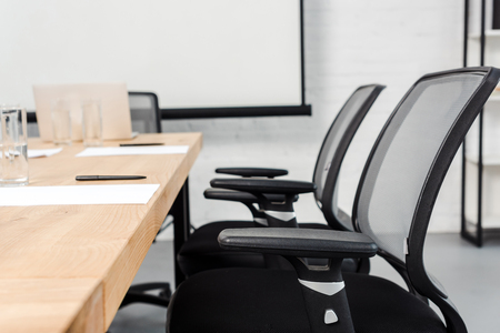 close-up shot of chair standing at conference hall of modern officeの写真素材