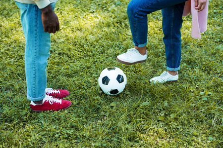 cropped image of african american couple playing football in parkの写真素材