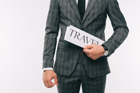 cropped image of businessman holding travel newspaper isolated on white