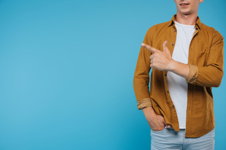 cropped image of man pointing on something isolated on blueの写真素材