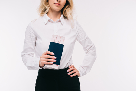 cropped image of businesswoman holding passport and ticket isolated on whiteの写真素材