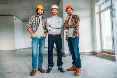 group of architects inside of constructing building looking at cameraの写真素材