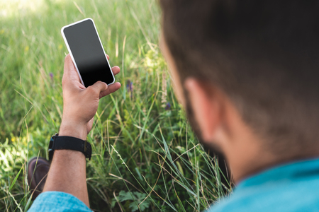 selective focus of man using smartphone with blank screenの写真素材