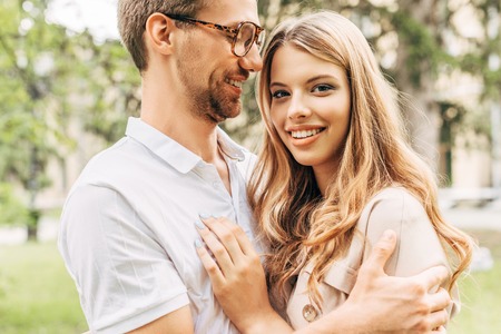 bottom view of happy young couple embracing at park