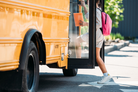 cropped shot of schoolgirl entering school busの写真素材