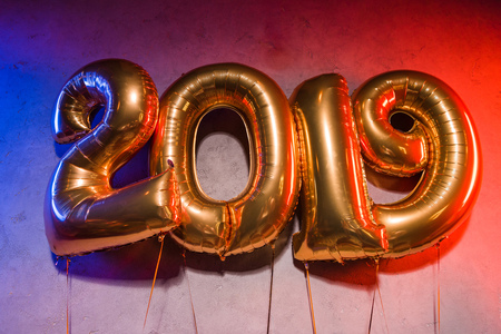 golden 2019 sign balloons with blue and red light on greyの写真素材
