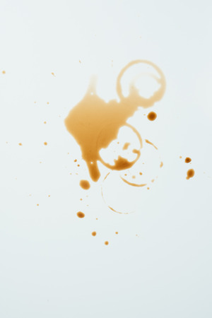 top view of messy white surface with coffee blotsの写真素材
