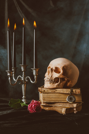halloween decorations and skull on black cloth with smokeの写真素材