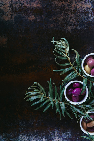 top view of tasty olives for oil preparation in bowls on shabby surfaceの写真素材