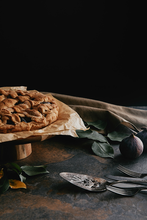 close up view of homemade pie on cake stand on grungy tabletop with black backgroundの写真素材