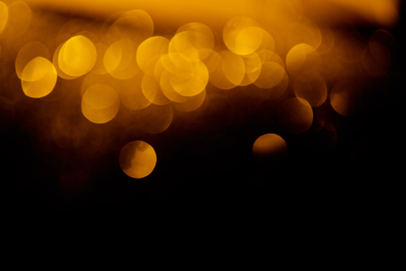festive golden bokeh on black background with copy spaceの写真素材
