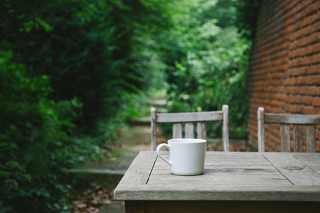selective focus of coffee cup on wooden tableの写真素材