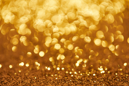 golden bokeh christmas background with glittering sequinsの写真素材