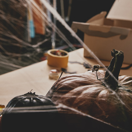 pumpkins and spiderweb on table, halloween conceptの写真素材